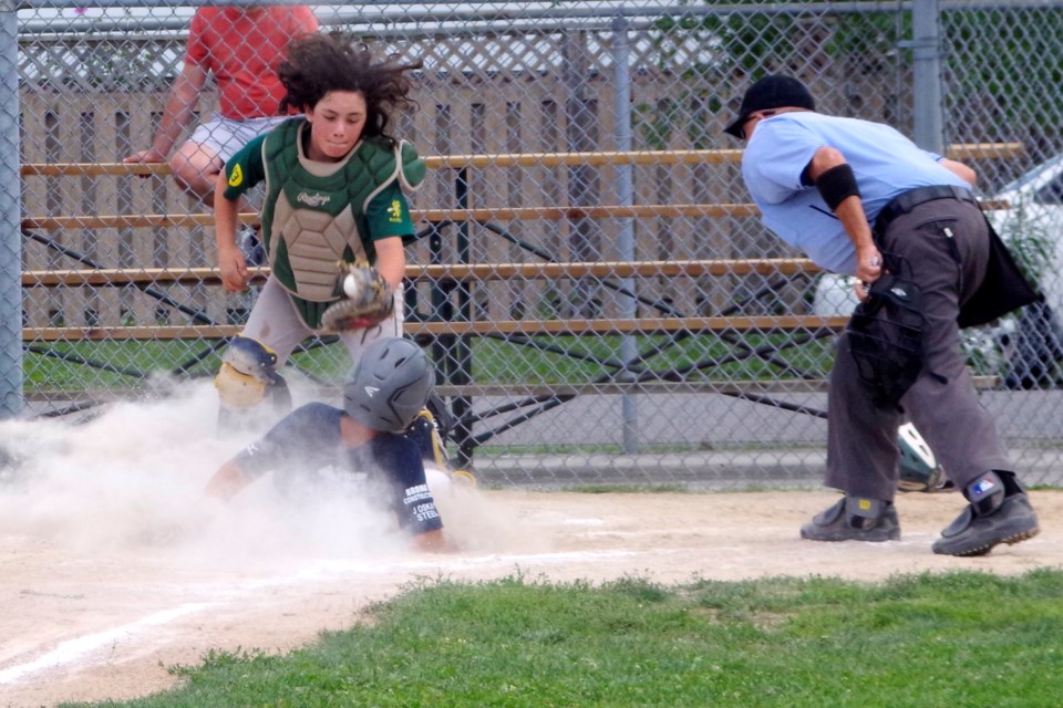 Brady Pearce of Pelham slides under the tag at home to score the first Pelham run. Bob Liddycoat / Thorold News