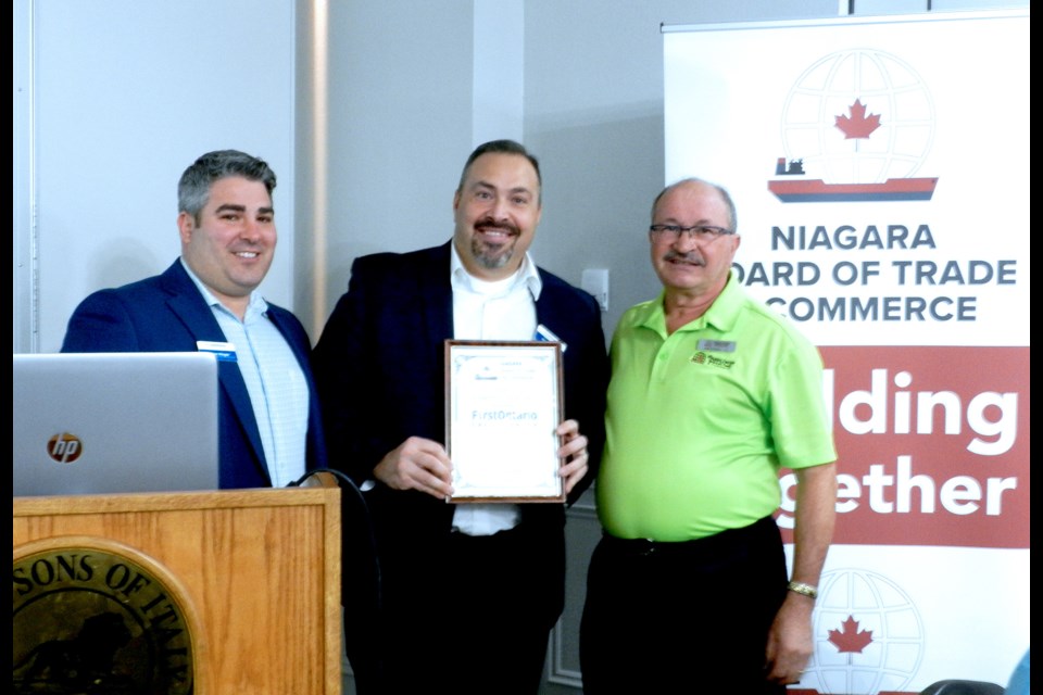 Adam Meger (l) and Vito DiPaola of First Ontario Credit Union receive a certificate of recognition from John D'Amico (r), president of the Niagara Board of Trade and Commerce.  Cathy Pelletier/ThoroldNews