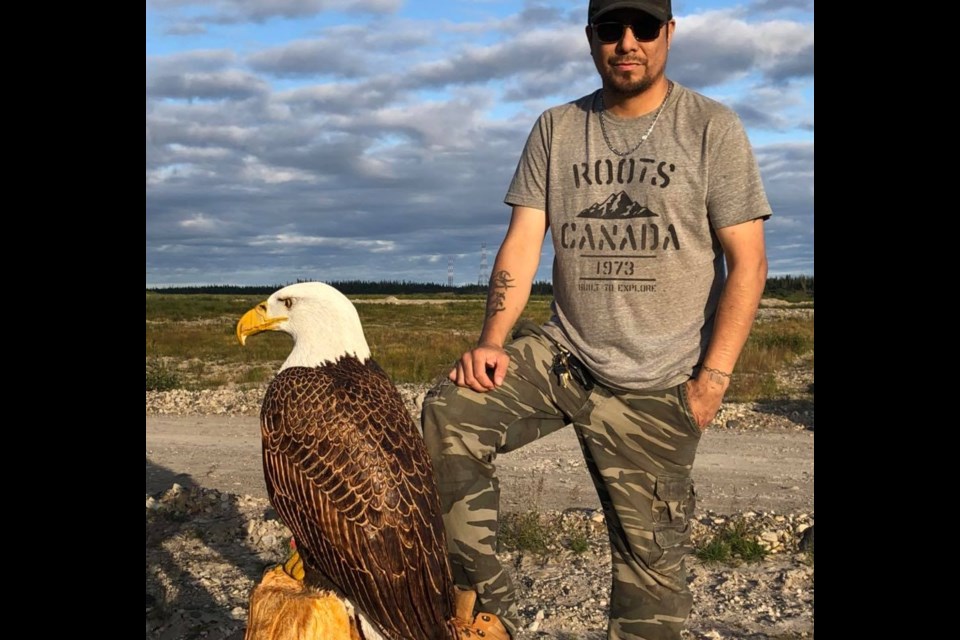 Kashechewan resident Jason Koosees with a full-size carved bald eagle. Supplied photo