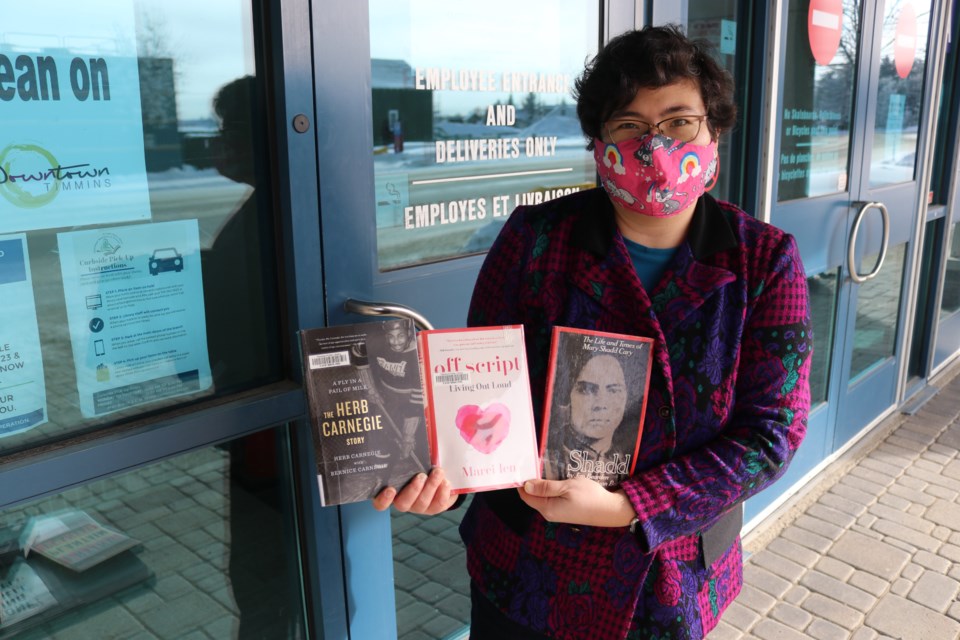 Karina Douglas Takayesu, the reference librarian at the Timmins Public Library, shows some of the books that can be read during Black History Month.