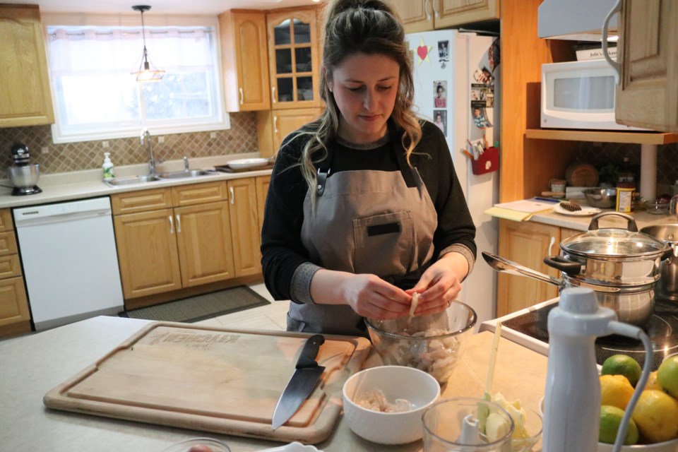 Julie Lefebvre prepares shrimps for a cooking workshop held as part of the Bonhomme Carnaval.