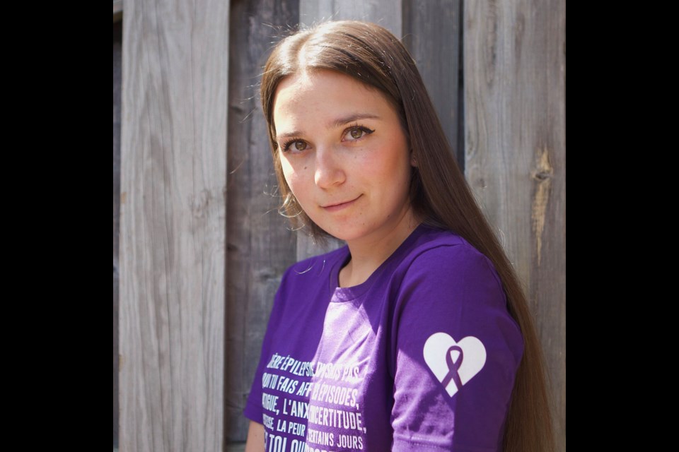 Céleste Lévis wears a "Dear Epilepsy" T-shirt with a message written in French. The T-shirt is be available to buy on the Epilepsy Shop website.