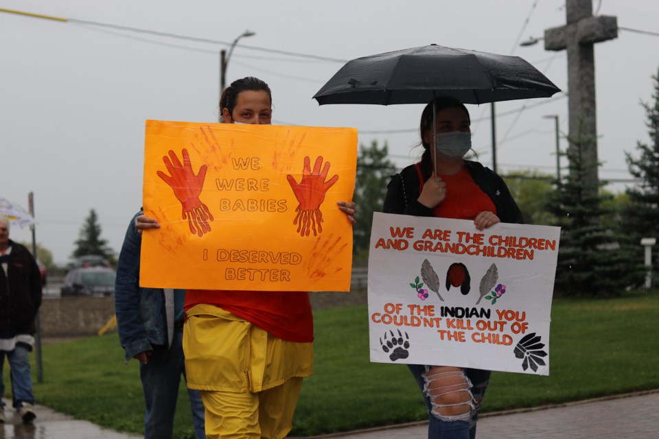 About a dozen people came to St. Anthony of Padua Cathedral Sunday to raise awareness about residential schools and demand answers about missing and murdered Indigenous children.