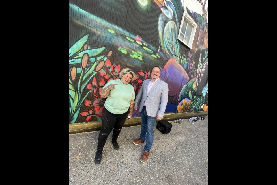 Mique Michelle and Coun. Cory Robin at the unveiling of a new mural downtown Timmins. The mural was completed as part of the filming for a new TV show called Couleurs Du Nord.