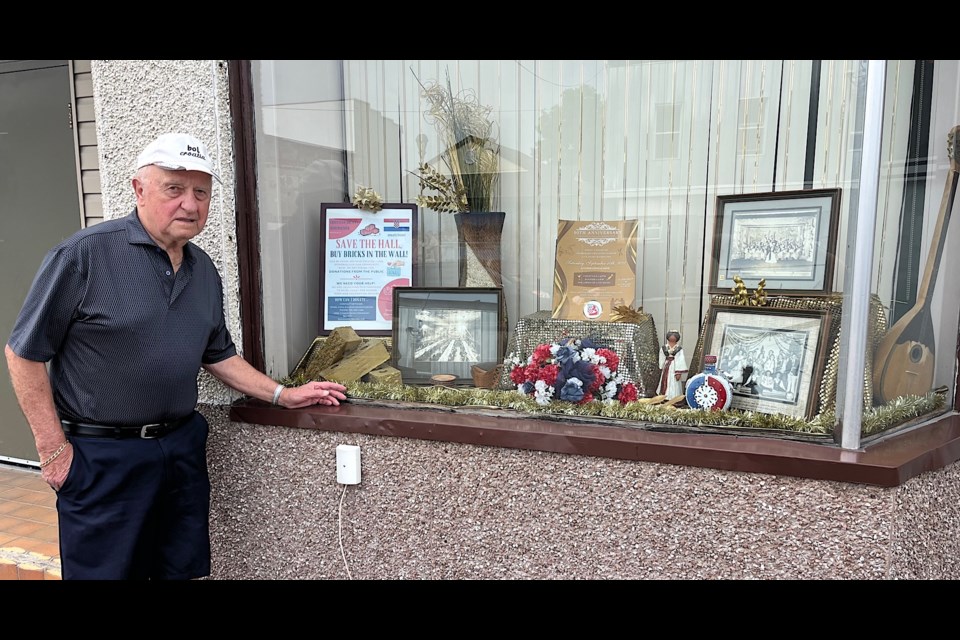 George Stefanic, secretary/treasurer of the Croatian Society: Schumacher, checks out the display window of The Croatian Hall. The hall has been a key part of the community for 90 years.