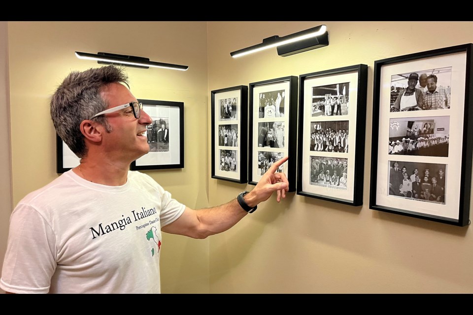 Dr. Chris Loreto, a director on the executive of The Dante Club, is well-versed in club history. Here he looks at some of the old  photos hanging inside the entrance.