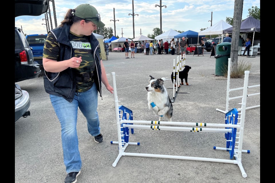 Alyssa McKean encourages her dog Kai to make a jump at the Mountjoy Farmers's Market. McKean is a RVT (Registered Veterinary Technician) -Trainer with The Dog Gym in Timmins.