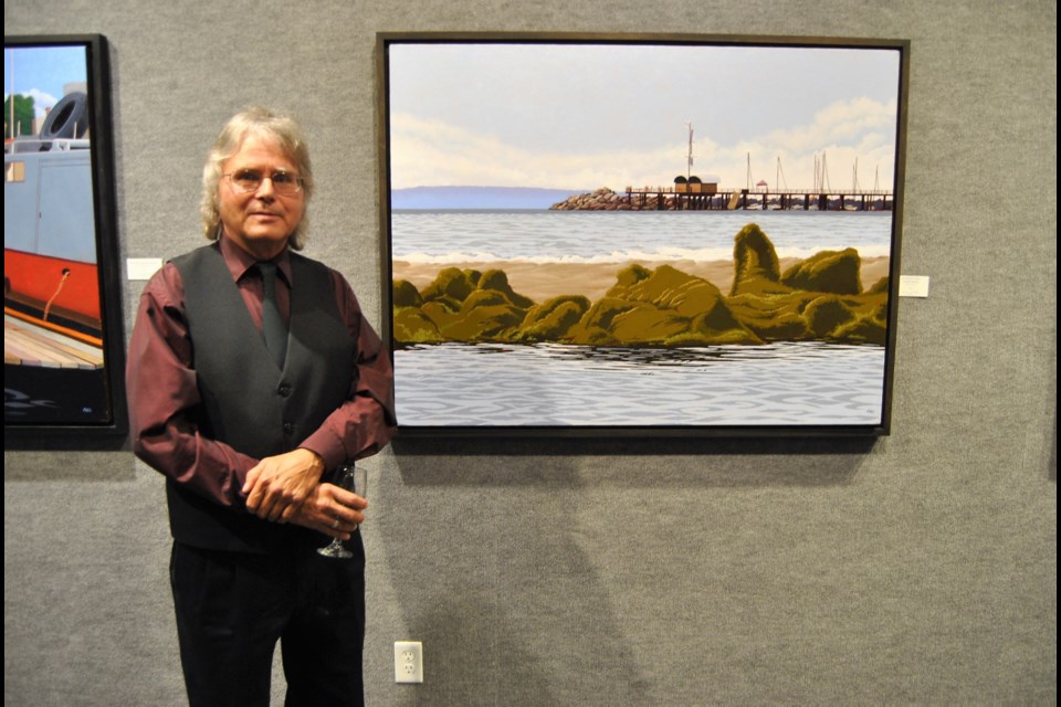 Michael Glover's art is on display at the Timmins Museum from September 15 to October 29. Michael standing beside his painting of an Nova Scotia ocean side scene. Frank Giorno for TimminsToday.