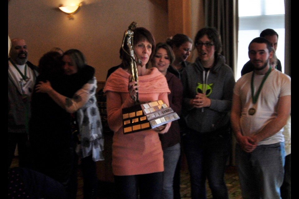 Actress Catherina Warren carries the trophy for the Most Outstanding Production Award handed out to Sault Theatre Workshop performance of 
