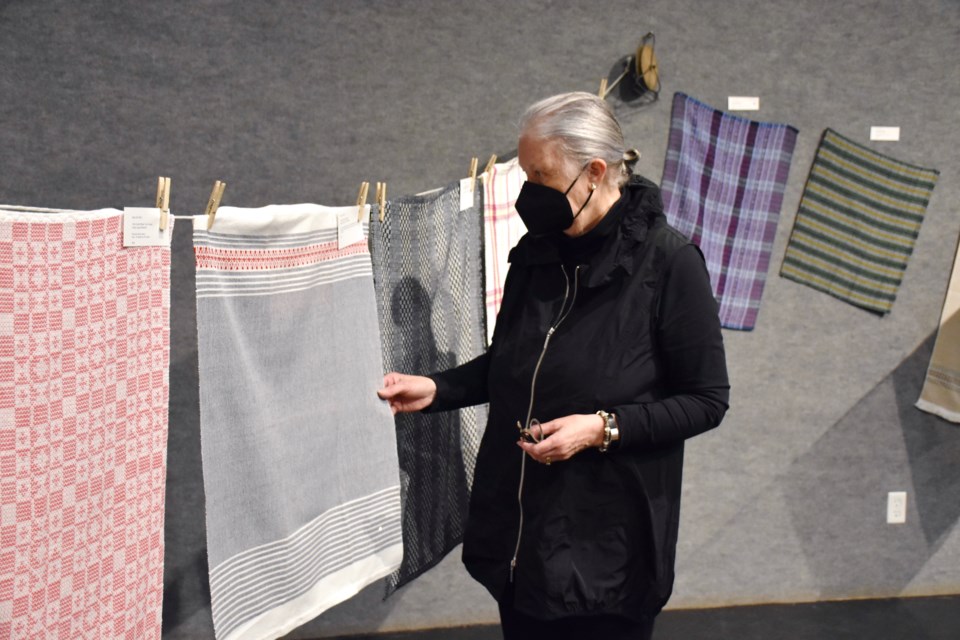 The Porcupine Handweavers and Spinners Guild's Susan O'Riordan with tea towels displayed at the Timmins Museum: NEC for the club's 45th anniversary.