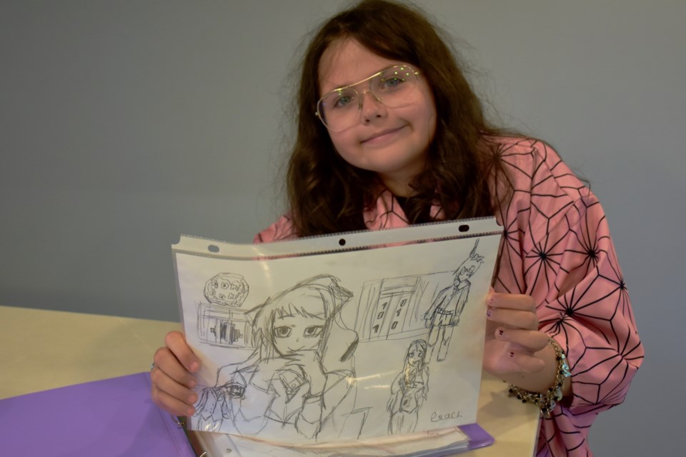Lilah Harmanmaa shows off some of her artwork. The nine-year-old is taking part in the Toronto Fan Expo Aug. 25-28.