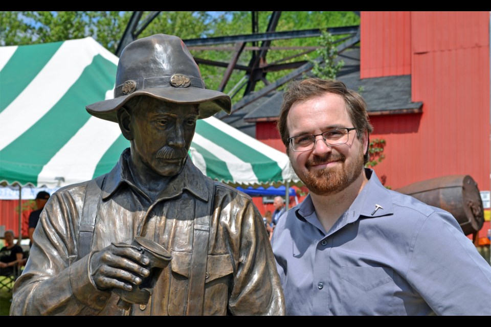 Sculptor Tyler Fauvelle with the Kirkland Lake Centennial Prospector monument. Supplied photo