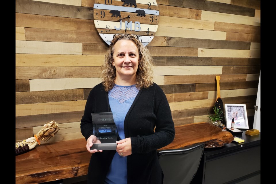 JMB Bookkeeping and Consulting owner Jeanna-Marie Bennett showing-off the 2021 Firm of the Year trophy.