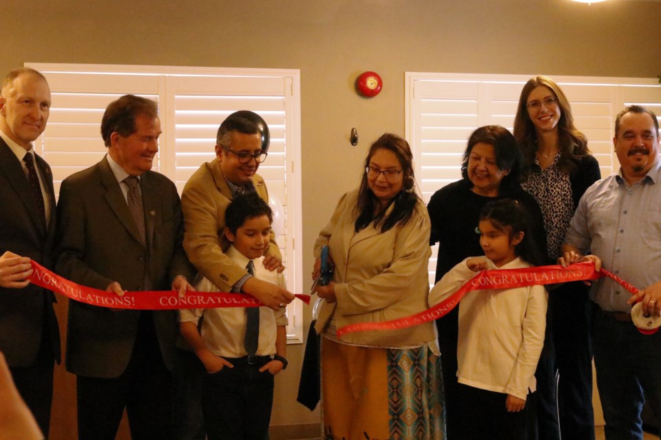Louise Spence-Mohamed cut the ribbon for her new office space in downtown Timmins with help from her family, MPP George Pirie, Mayor Michelle Boileau, and representative from MP Charlie Angus's office and the Timmins BIA.