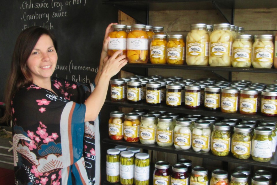 Becky Lefebvre, owner of The Urban Farm in South Porcupine, displays some of the preserves offered at the store. The Urban Farm sells farm fresh food, including locally produced vegetables, meat, eggs and baked goods. Wayne Snider for TimminsToday