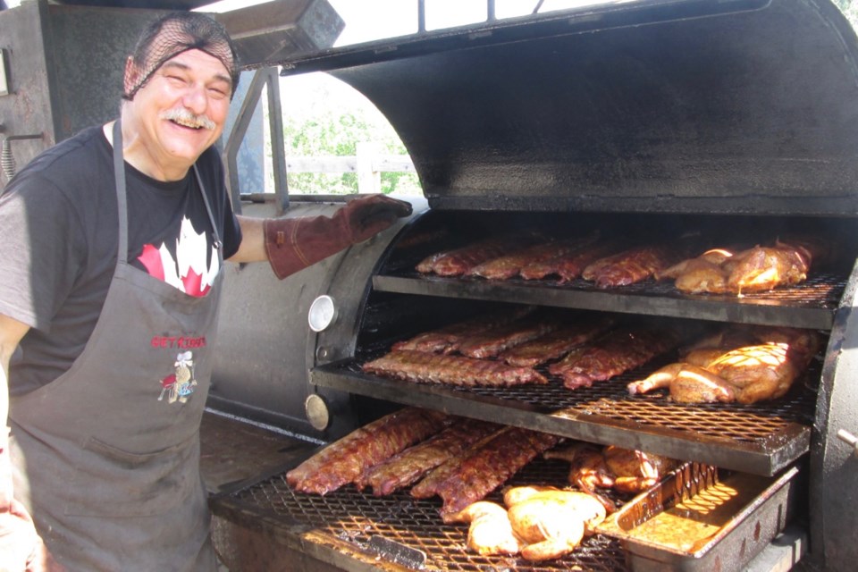 Dale Dupras, owner of Get Ribbed Smokehouse and BBQ, displays the ribs and chicken as they slowly cook on his custom smoker. The business has been nominated for Best Takeaway in the First Ontario Foods Awards.  Wayne Snider for TimminsToday
