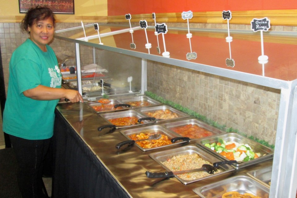 Estela Chow, owner of the Lady Luck Buffet and Restaurant, displays the buffet, which features a mix of Filipino and Canadian cuisine. Nothing goes to waste as at the end of the day leftovers are donated to the Living Space and the Good Samaritan Inn. Wayne Snider for TimminsToday