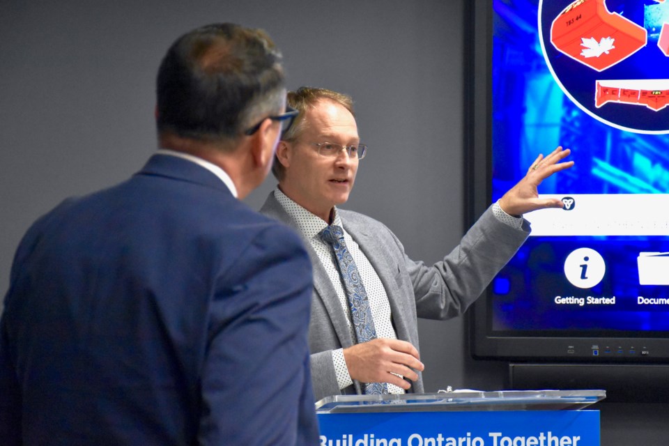 The Bucket Shop's Jamie Pouw explains how the Timmins company is investing nearly $600,000 it's receiving from the Northern Ontario Heritage Fund Corporation (NOHFC) while Minister of Energy, Northern Development and Mines Greg Rickford looks on. Maija Hoggett/TimminsToday