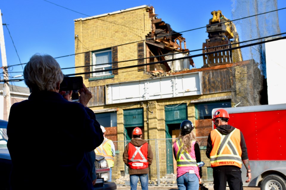 People in South Porcupine stopped for videos and photos of The Central Tavern being torn down. Maija Hoggett/TimminsToday