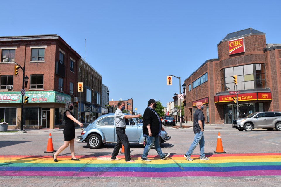 Chrislynn Losier, Timmins Mayor George Pirie, and Matthieu Villeneuve take part in the official opening of the Pride crosswalk downtown Timmins.