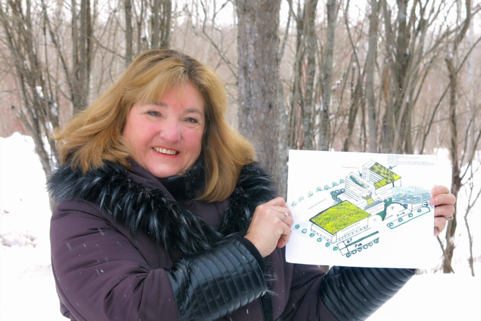 Carol Tanguay with the mock-up of the Porcupine Grand Phoenix Hotel.