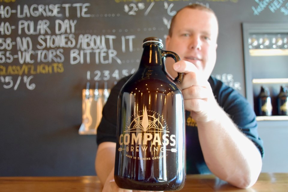Kevin Patriquin, one of the four owners of Compass Brewing, with a freshly-filled growler. Maija Hoggett/TimminsToday