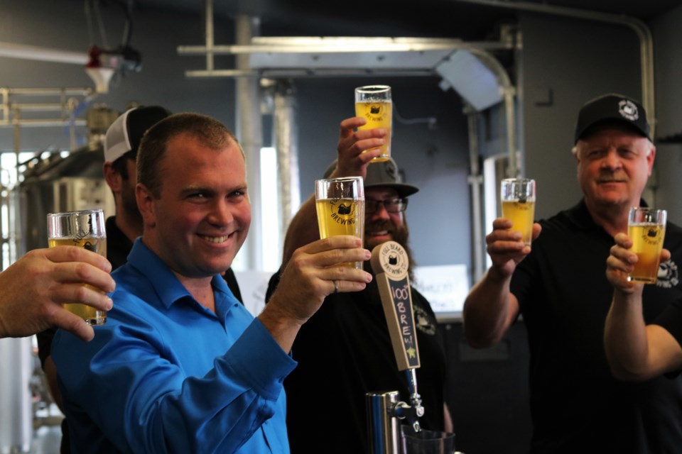 Mayor Steve Black raises a glass along with brewery staff at the official grand opening of Full Beard Brewing's facility on Rea Street South. Andrew Autio for TimminsToday