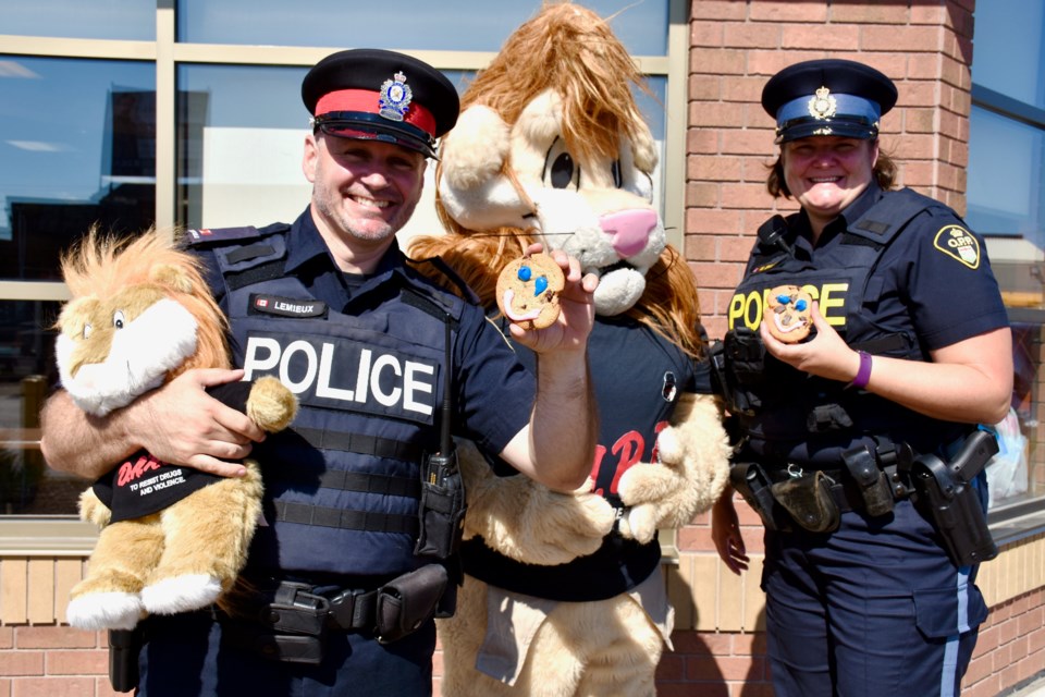 Timmins Police Const. Rick Lemieux, Daren, and OPP Const. Michelle Simard are excited for the launch of the Smile Cookie campaign, which is supporting DARE programming in Timmins. Maija Hoggett/TimminsToday