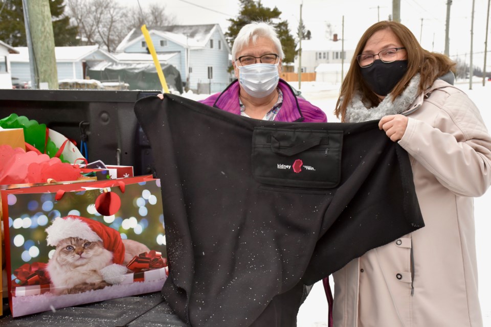 Marlene Smith and Joanne Hagger-Perritt with one of the blankets dialysis patients at Timmins and District Hospital received from the local chapter of the Kidney Foundation.