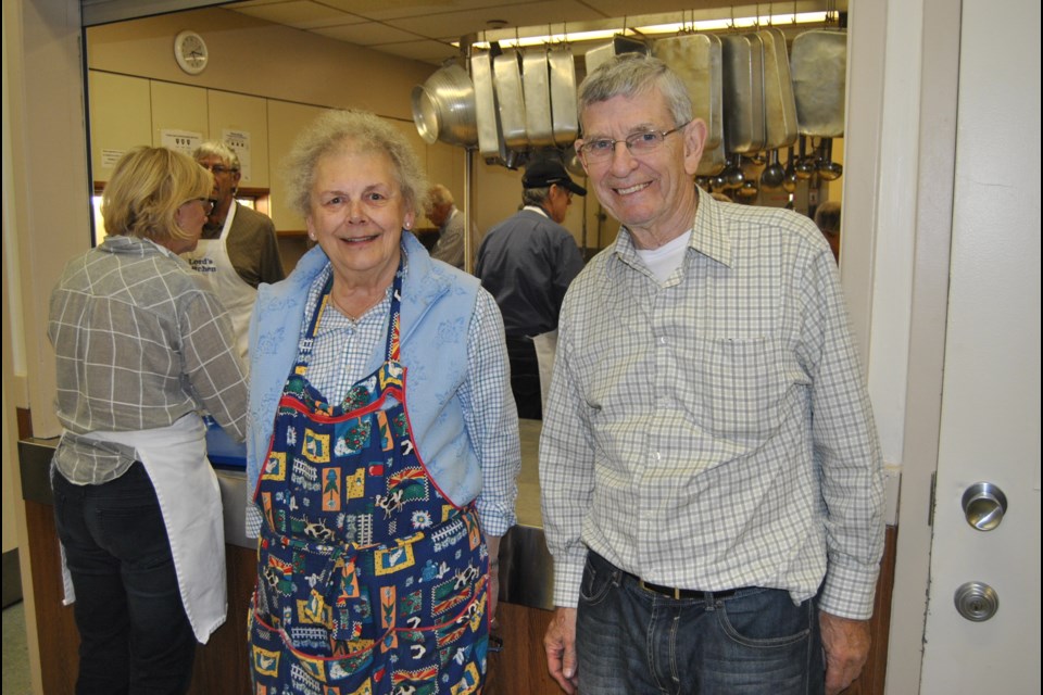 Phil Kelly, President of the Lord's Kitchen Society, and volunteer Dianna Russell, help serve dinner for over 220 people on Thursday October 6, 2016. Photo: Frank Giorno, Timminstoday.com