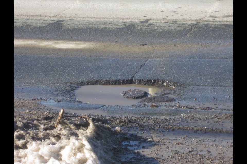 A sketchy looking pothole collects water on Algonquin Boulevard East. Andrew Autio for TimminsToday                               