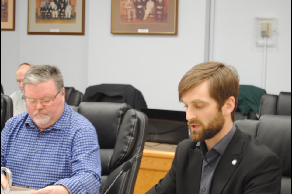 Councillor Andre Grzela (right) introduces resolution calling on Ontario government to regulate gasoline prices in the province. Councillor Andrew Marks seated to his left.