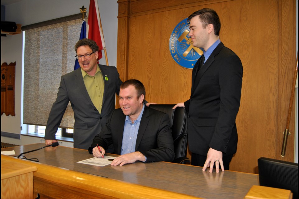 Mayor Steve Black (seated) proclaims March, 2017 to be Engineering Month in Timmins. With him are Tony Linton (left) Dumas Mining and Corey Goulet (right) Timmins Chapter Professional Engineers of Ontario. Frank Giorno for TimminsToday.