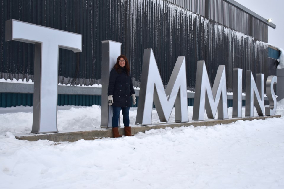 Monica Towsley poses with the new photo-worthy Timmins sign outside the Timmins Museum: National Exhibition Centre. Maija Hoggett/TimminsToday