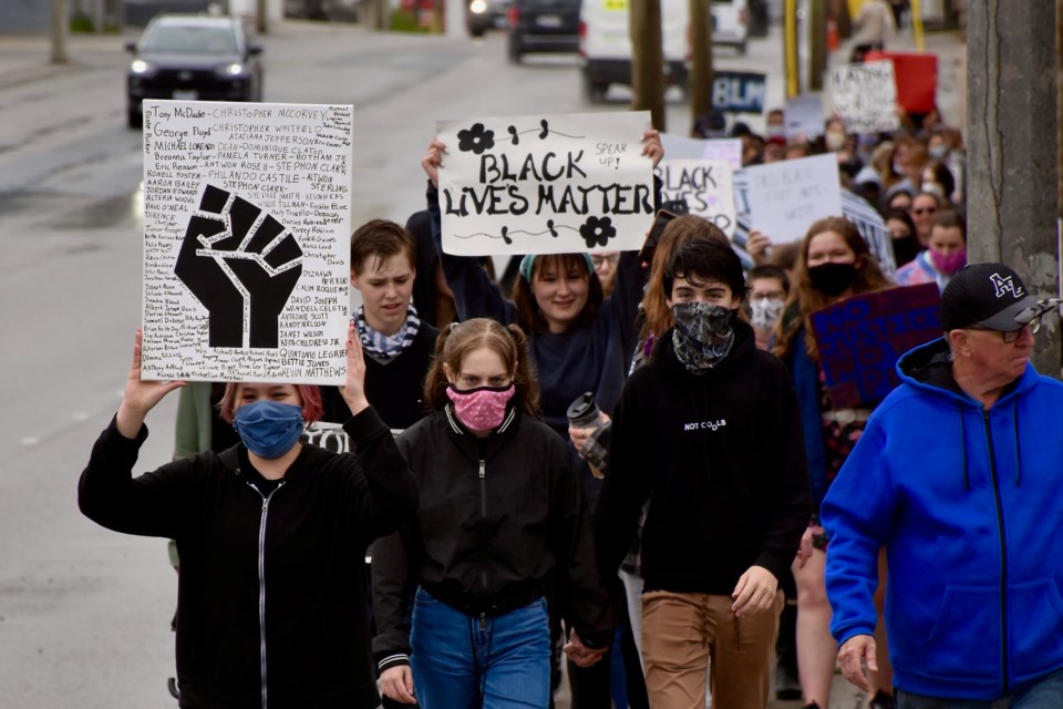 Black Lives Matter Timmins organizer Kendrick (left) leads the march down Algonquin Boulevard to city hall. The anti-racism event attracted about 100 people on a rainy afternoon. Maija Hoggett/TimminsToday