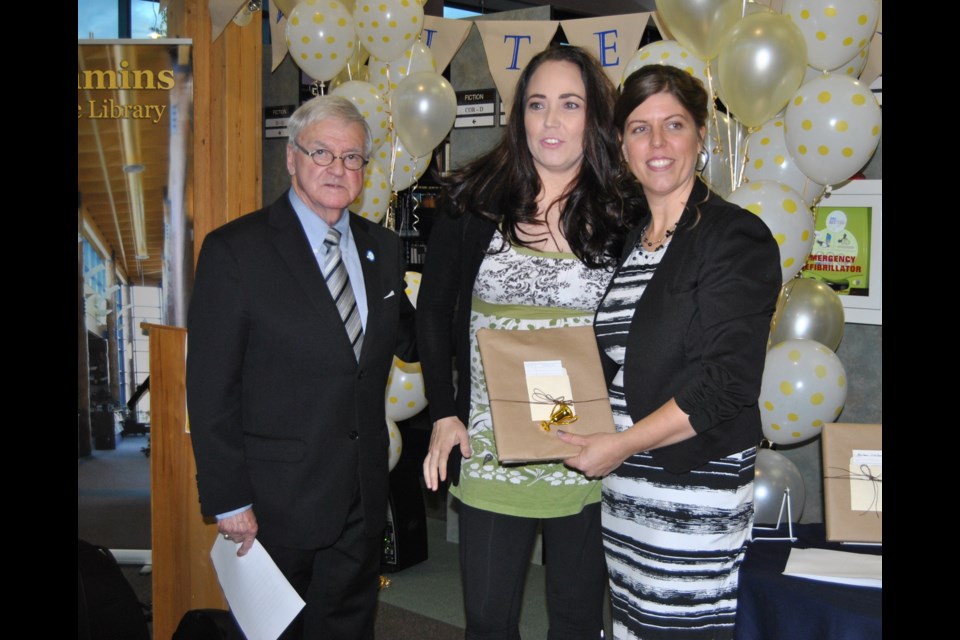 Melanie Watson (centre), Timmins teacher, wins first Write It to Win It short story contest. She is flanked by Councillor Michael Doody (left) and Carol Anne Churcher (right). Frank Giorno for TimminsToday.