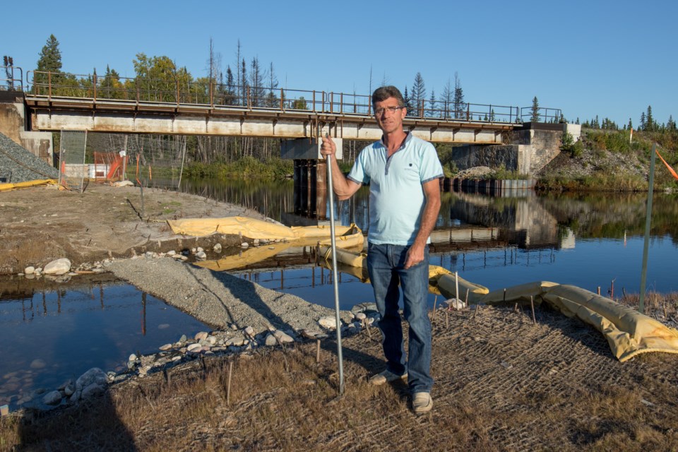 Gogama fire chief Mike Benson stands in front of the Makami River on the spot where a train derailment and oil spill occurred in March 2015. Benson has been in the press as a vocal critic of CN's cleanup efforts. He recently recounted his experiences as a first responder. Jeff Klassen/TimminsToday
