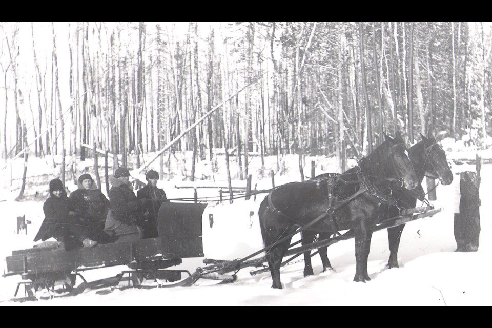 Four men are warmly bundled up and ready for a Christmas sleigh ride around the Porcupine Gold Camp. Timmins Museum: National Exhibition Centre photo