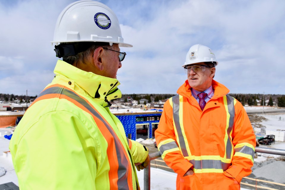 Integrated Emergency Services Complex project manager Fred Trembinski and Northern College president Fred Gibbons tour the building, which is currently under construction and is expected to be finished in time for school in September. Maija Hoggett/TimminsToday