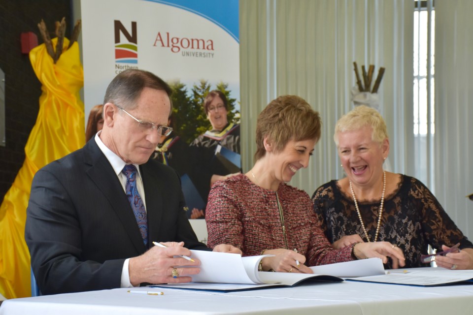 Northern College president Fred Gibbons and Algoma University president Asima Vezina sign new academic pathway and updated joint admission agreements. Maija Hoggett/TimminsToday