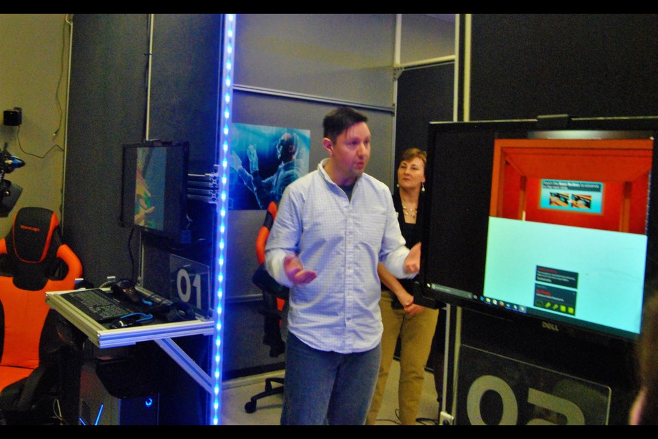 William Desrochers, an instructor in the business department, has become the lead technician in set up Northern College's Virtual Training Centre. Here he explains how the Centre operates. Two interactive virtual training stations can be seen, one on the left and the other on the right. Frank Giorno for TimminsToday.