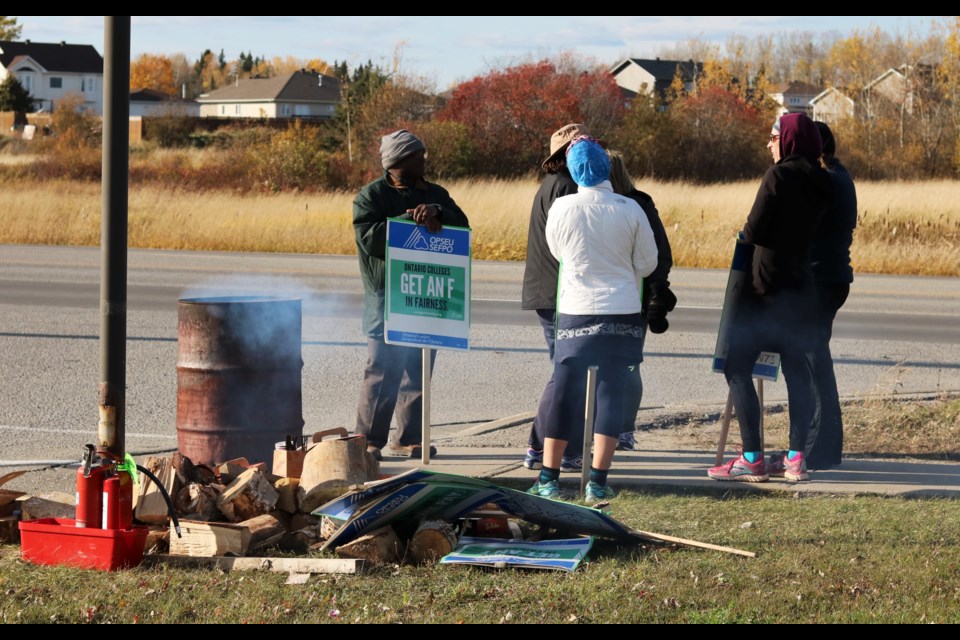 Lad Shaba, left, and his colleagues from OPSEU local 653, picket on the edges of Northern College's Porcupine campus. Andrew Autio for TimminsToday