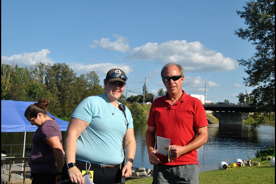 Lacy Rigg, from the Great Canadian Kayak Challenge and Festival presents the first prize award in the men's 32 km elite division to Dorion Malloy. Frank Giorno for Timminstoday.