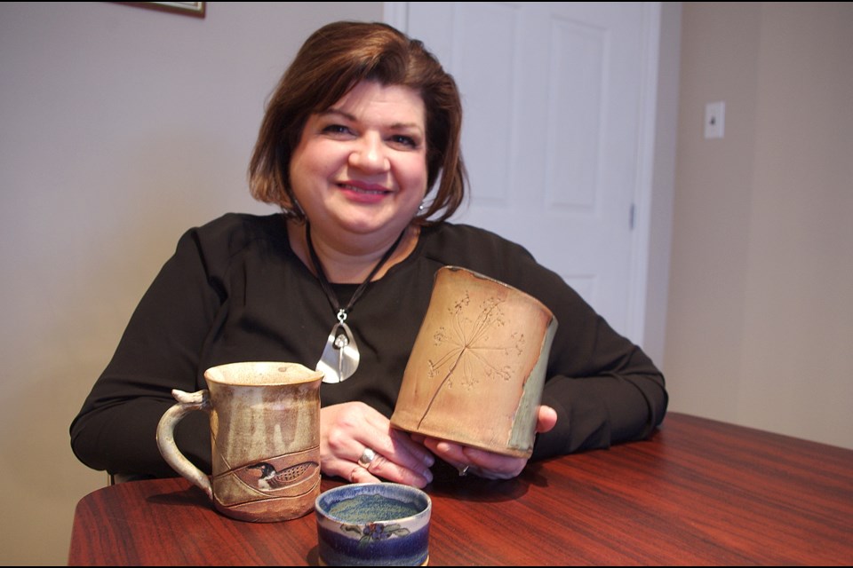 Chantal Yu with Otti Twardowski's pottery, which is being auctioned off Nov. 10 and 11 at the Senator Hotel in Timmins. Maija Hoggett/TimminsToday