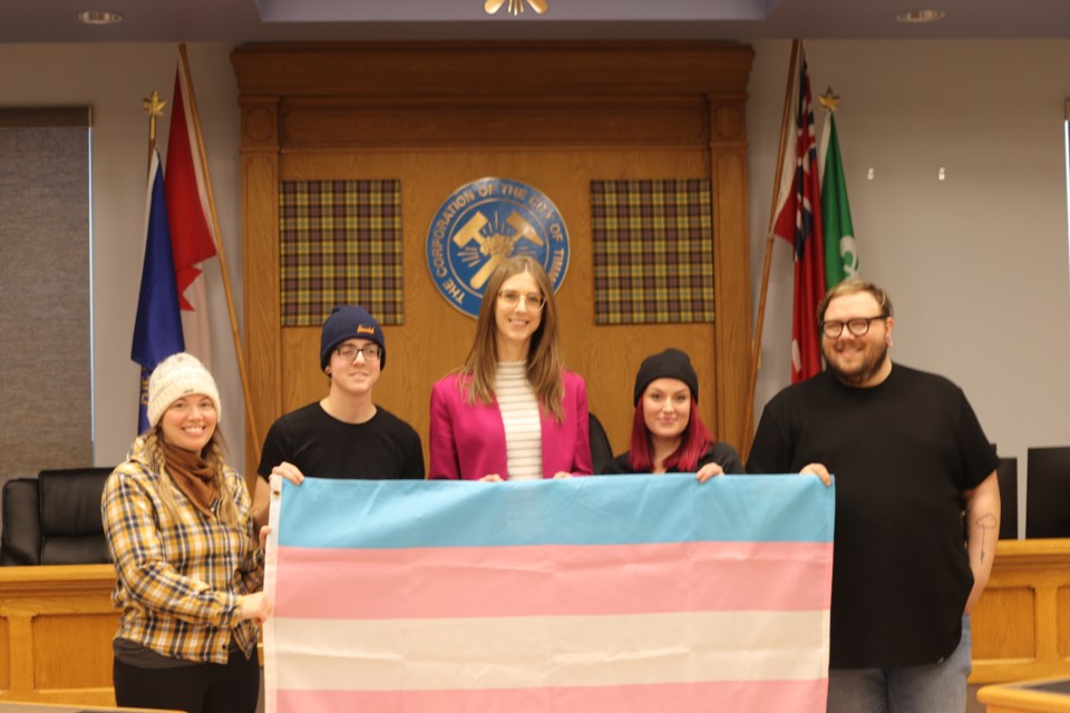 Fierté Timmins Pride board and Mayor Michelle Boileau with the trans flag.