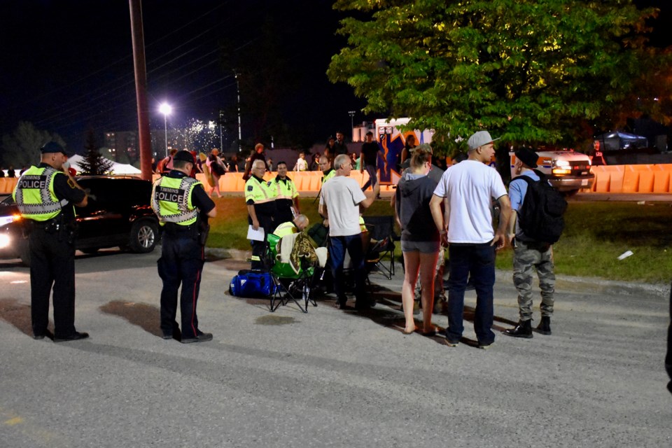 First responders make sure Chantal Mailloux is okay after a firework launched into the parking lot Saturday night. Maija Hoggett/TimminsToday