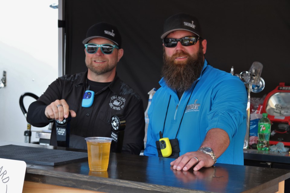 Benjie Potvin (left) and Jonathan St. Pierre of Full Beard Brewing have been kept extremely busy at the Stars and Thunder festival. Andrew Autio for TimminsToday