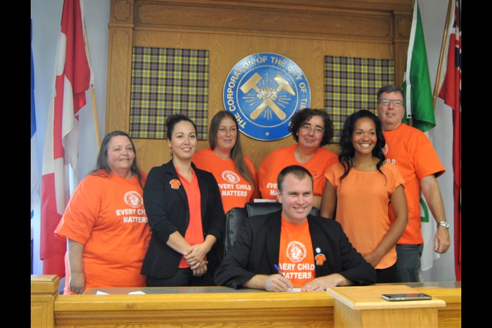 Mayor Steve Black Iseated, centre) proclaims Orange Shirt Day in Timmins surrounding by representatives from Timmins Native Friendship Centre, Timmins Police Services, Misiway Health Centre and French and English Catholic School Boards. Frank Giorno for TimminsToday.