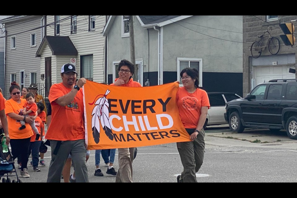 Walkers carried "Every Child Matters" banners along the Orange Shirt Day walk.