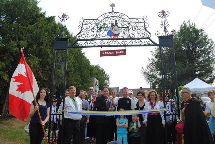 David Yaschyshyn and  Mayor Steve Black cut the ribbon to re-open Kobzar Park to the right of Mayor Black are  Councillor Noella Rinaldo, Susan Tesluk and Monsignor Lev Chayka. Frank Giorno/TimminsToday